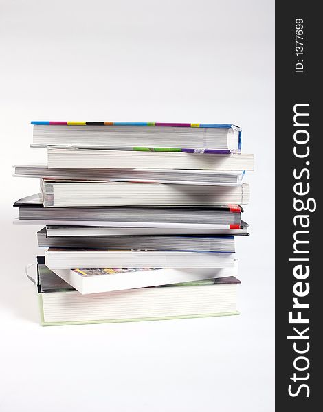 A stack of books against a white background.