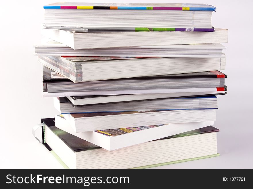 A stack of books against a white background.