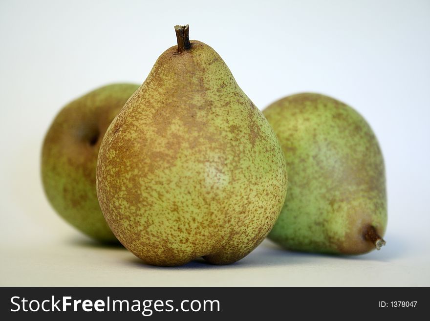 Three wild pears on white background