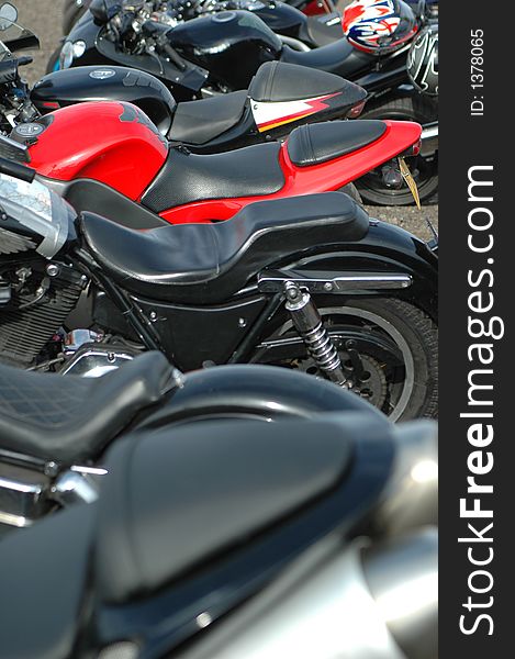 A mass of motorbikes with focal on red machine. A mass of motorbikes with focal on red machine.