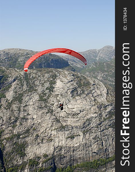 Picture of paraglider flying over Lysefjord in Norway. Picture of paraglider flying over Lysefjord in Norway.