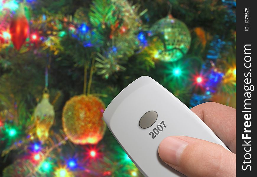 Remote control with one big button 2007 in hand, xmas tree