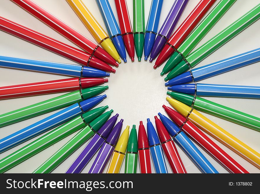 Several mlti colored pencils arranged in a circular pattern. Several mlti colored pencils arranged in a circular pattern