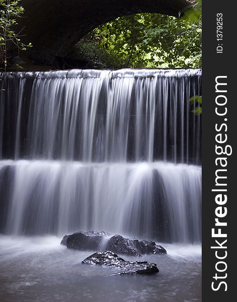 A Waterfall under a Bridge in Honiton, Devon.U.K. A Waterfall under a Bridge in Honiton, Devon.U.K