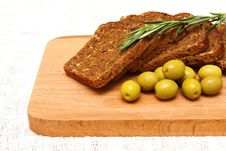 Bread, Olives, Rosemary And Wooden Board Royalty Free Stock Photos