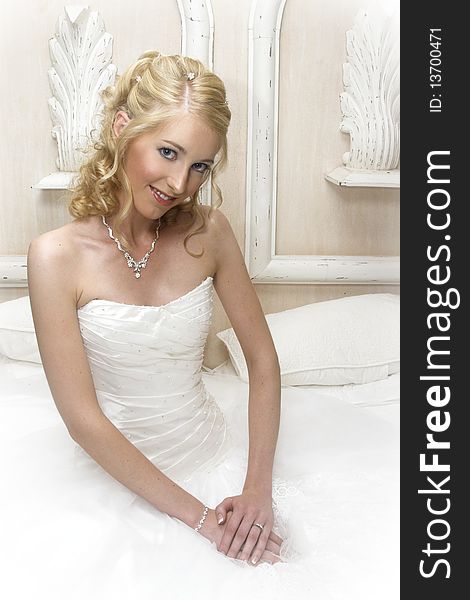 Beautiful Blond bride wearing diamond jewelery and a white gown