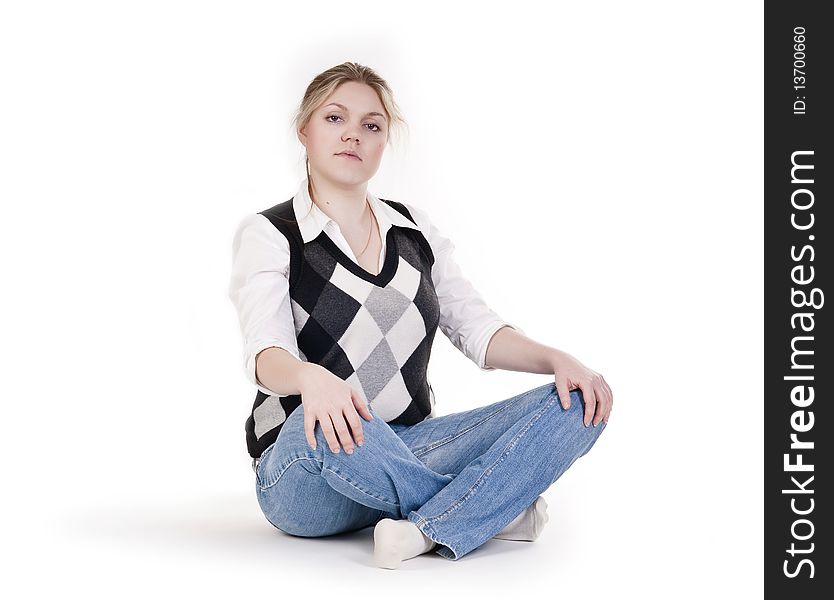 Isolated Pretty Blond Young Woman In Blue Jeans Sitting With Her Legs Crossed. Isolated Pretty Blond Young Woman In Blue Jeans Sitting With Her Legs Crossed