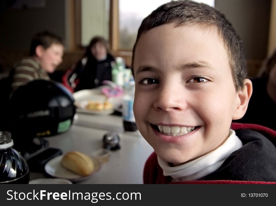 Smiling Boy Eating Lunch After Skiing. Smiling Boy Eating Lunch After Skiing