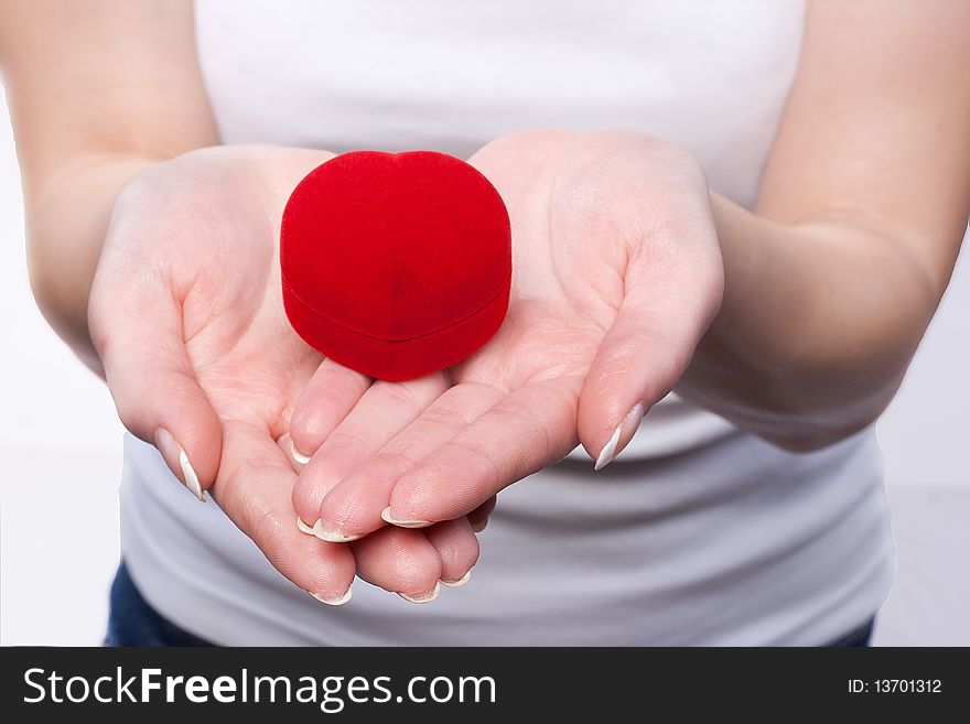 Close up photo of a red velvet box in a female hands