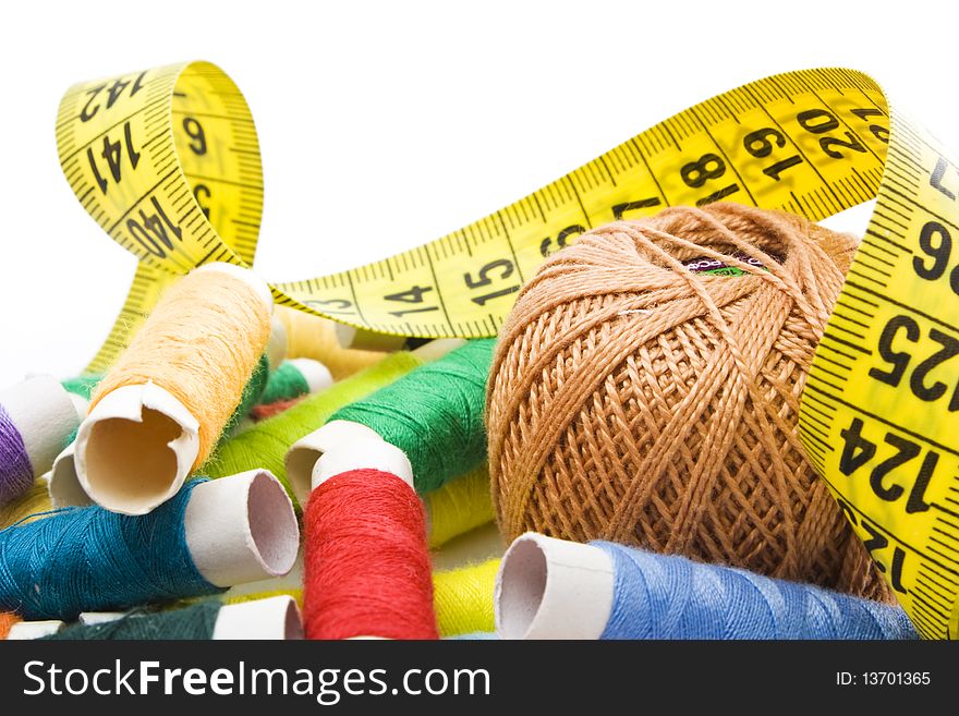 Colorful thread with measuring tape isolated in white background