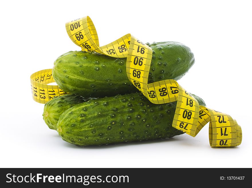 Cucumbers with a measuring tape isolated on white