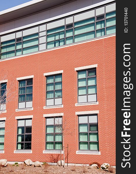 Modern brick and glass building in spring