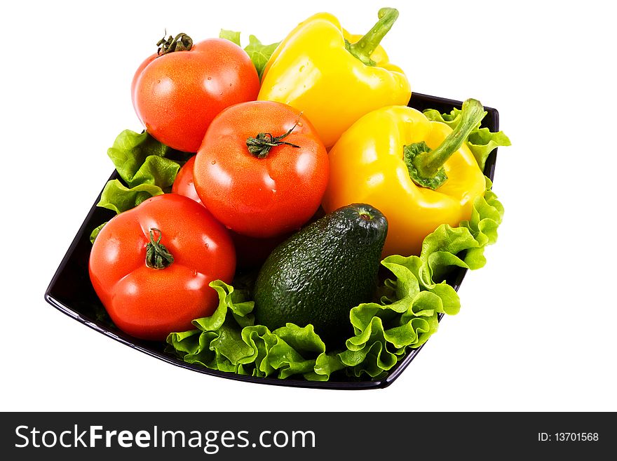 Fresh vegetables for salad in black bowl isolated on white background. Fresh vegetables for salad in black bowl isolated on white background