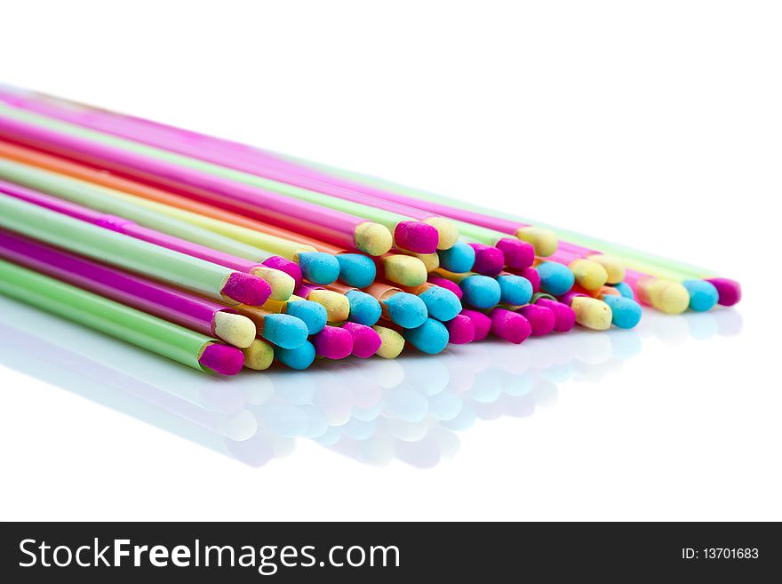 Pile of colorful matches, reflected from the white surface. Pile of colorful matches, reflected from the white surface