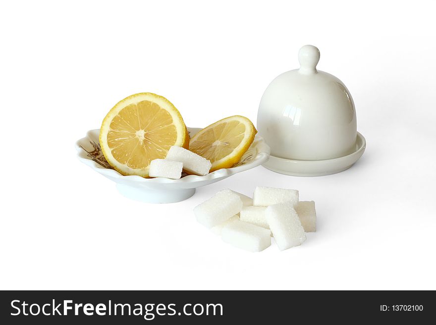 Slices of sugar and the cut lemon on a white background. Slices of sugar and the cut lemon on a white background