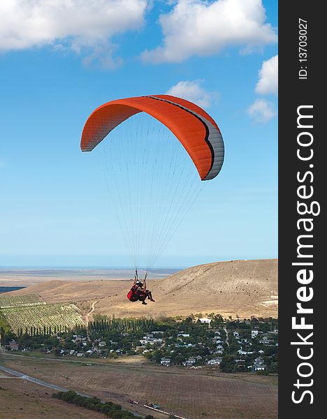 Tandem paragliding in blue sky