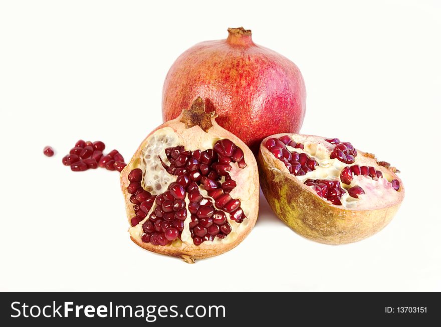Pomegranate halves on a white background. Pomegranate halves on a white background