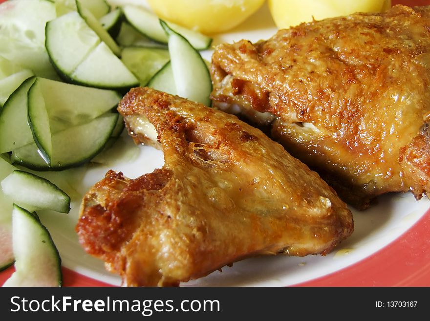 Grilled chicken with cucumber salad on a plate
