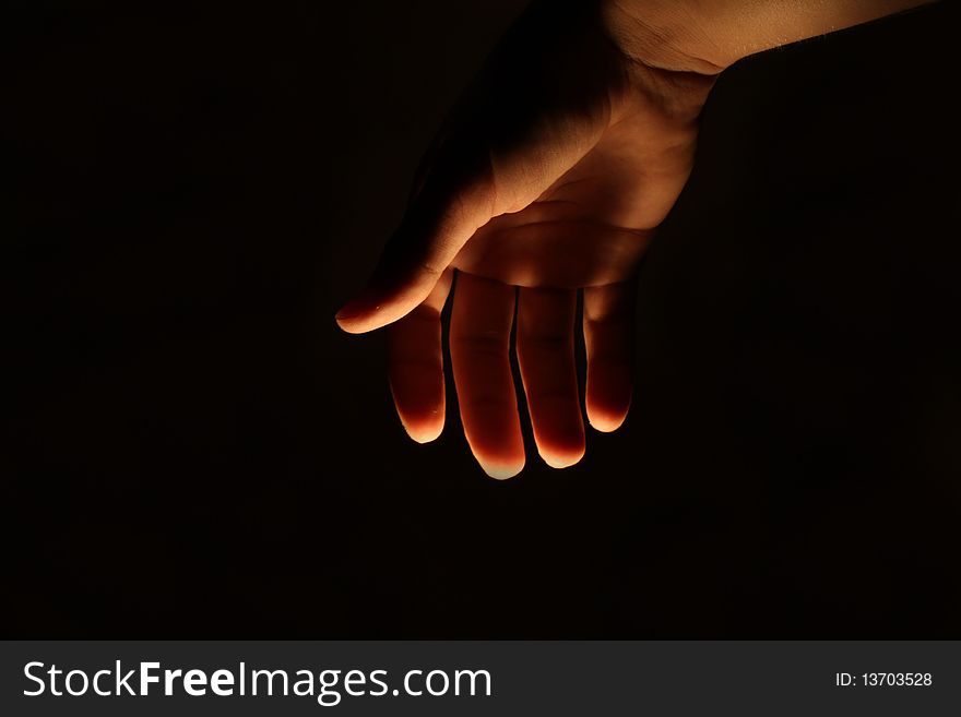 Human man hand lighted from beneath. Human man hand lighted from beneath