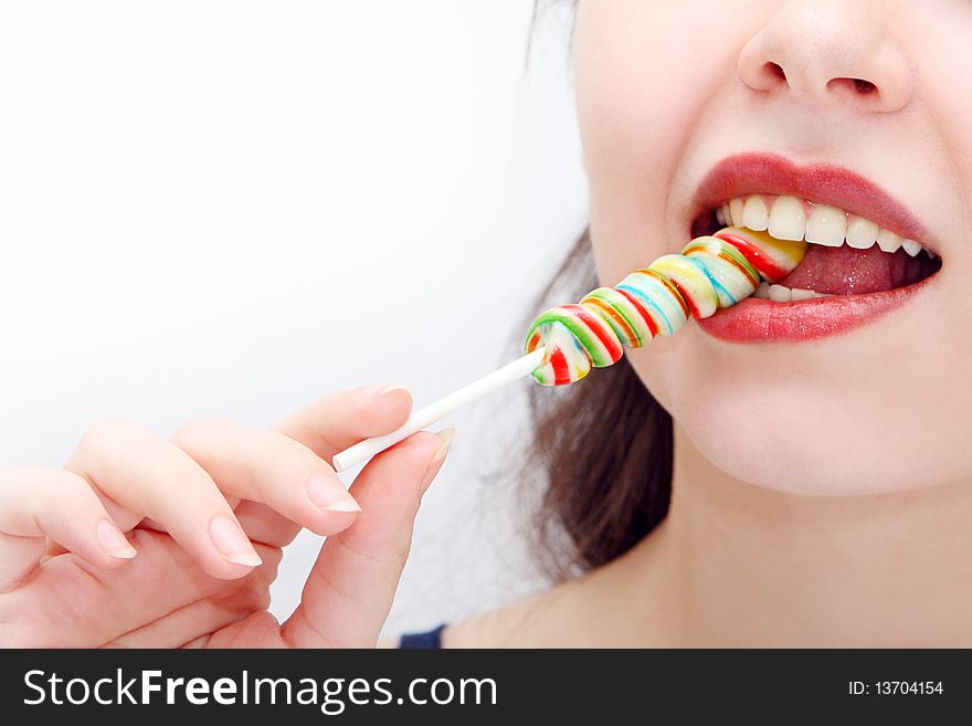Young woman's mouth with lollipop.