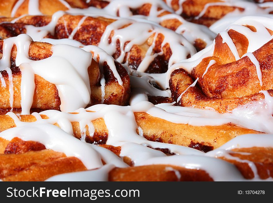 The sweet pie with cinnamon is watered from above by sugar glaze.