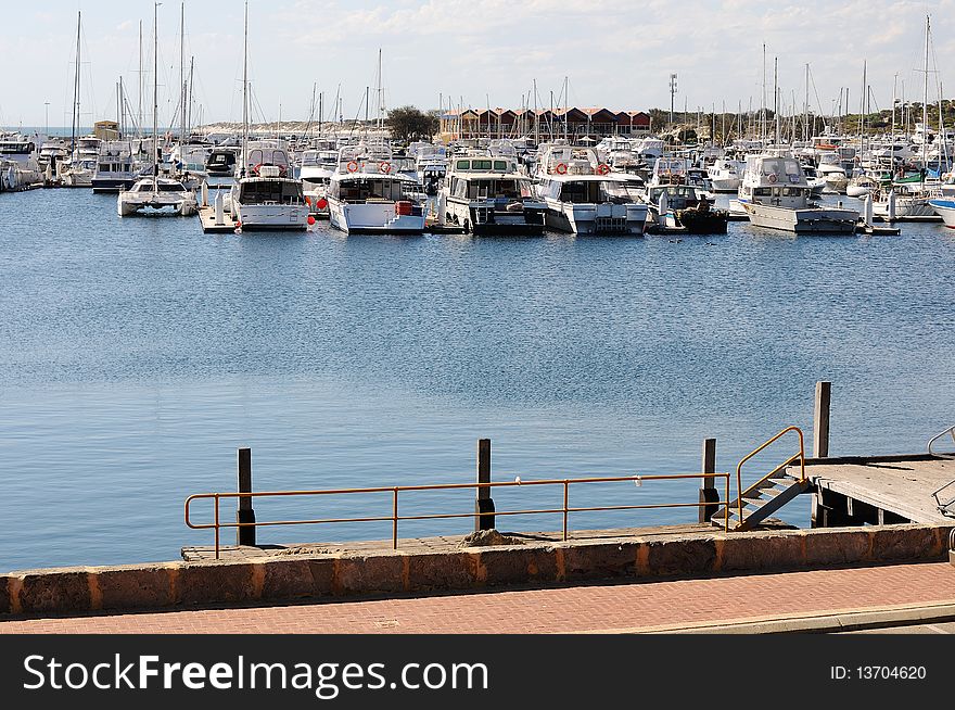 Large number of white yachts in the bay at the pier