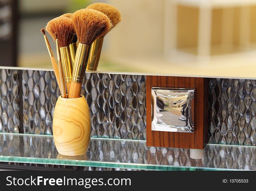 Brush for a make-up on a glass shelf