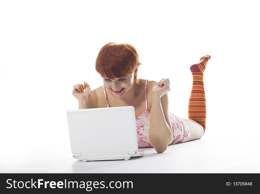Girl in striped socks look at notebook and smile at white background. Girl in striped socks look at notebook and smile at white background