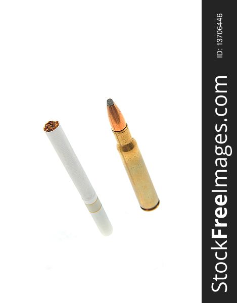One isolated bullet and one cigarette. One isolated bullet and one cigarette