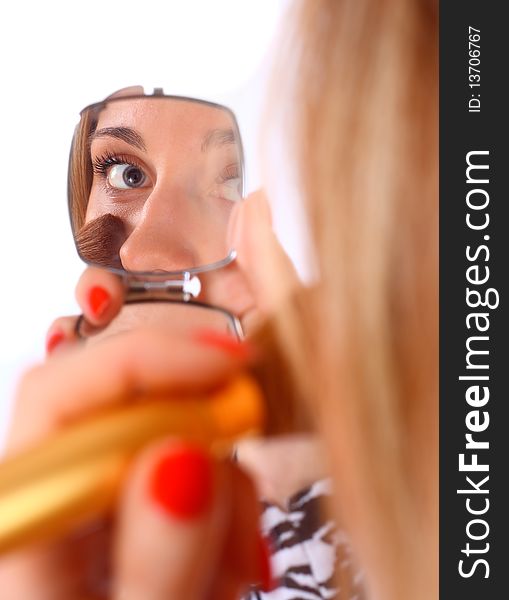 Woman looking in to the mirror, studio shot