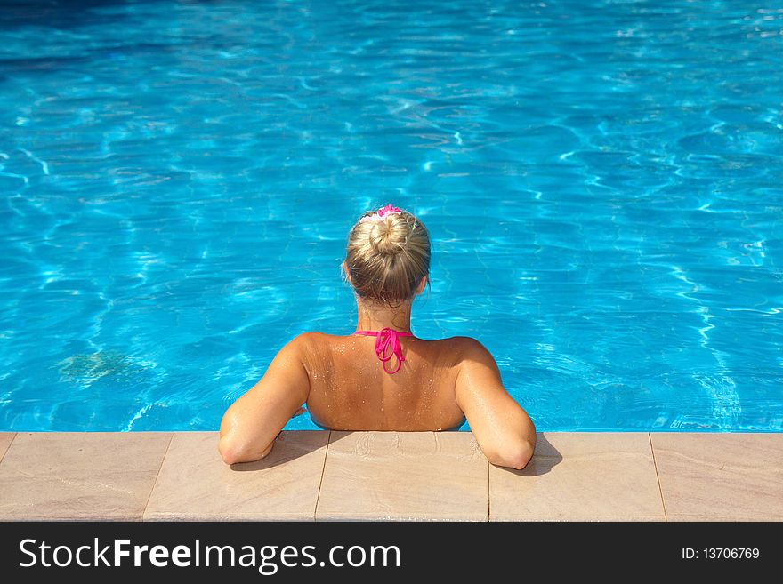 Caucasian blond woman sitting in pool