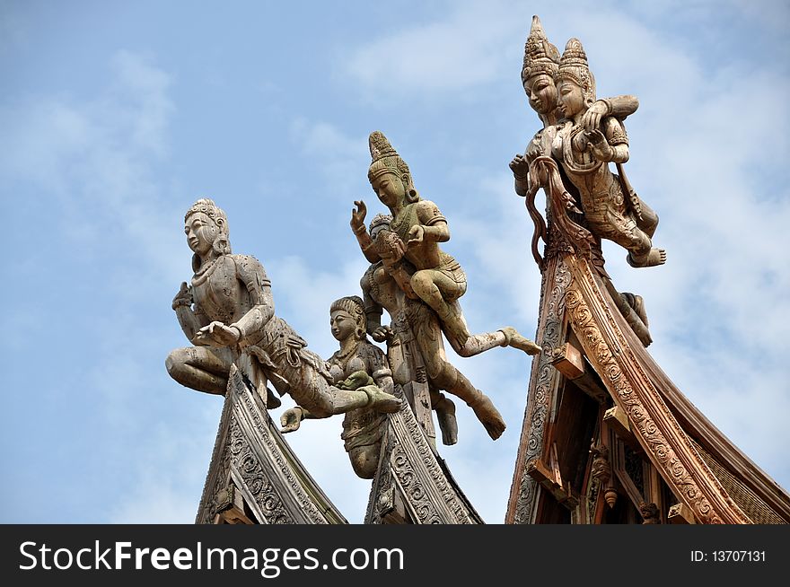 Exquisite hand carved wooden figures atop three flying-eaved roof gables at remarkable Sanctuary of Truth Temple in Pattaya, Thailand. Exquisite hand carved wooden figures atop three flying-eaved roof gables at remarkable Sanctuary of Truth Temple in Pattaya, Thailand.