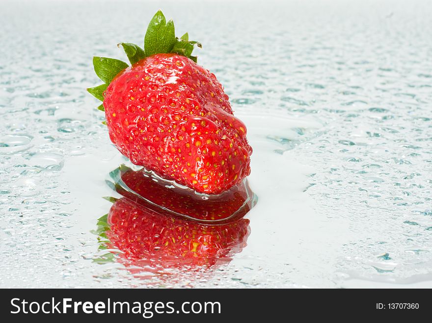 Juicy strawberries in drops of water with reflection. Juicy strawberries in drops of water with reflection
