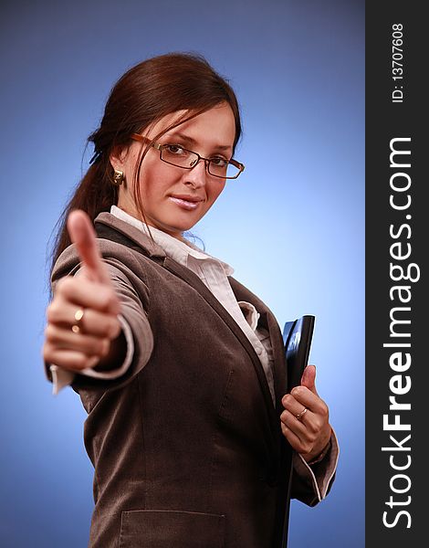 Young businesswoman showing thumb up. Young businesswoman showing thumb up