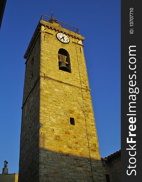 Bell tower of mougins's church in sunset on french riviera