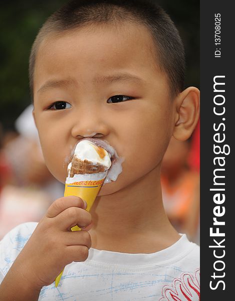 A boy lick and eats a butter icecream. A boy lick and eats a butter icecream.