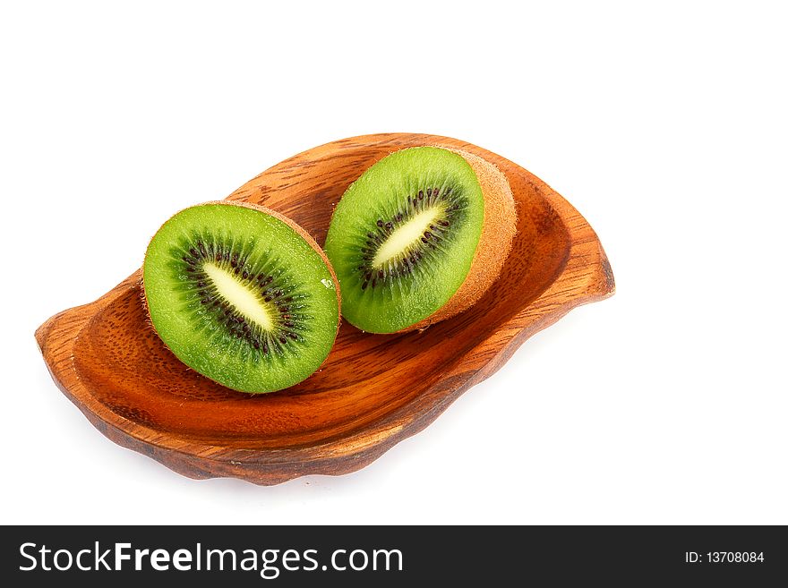 Kiwi fruit on a wooden plate. Isolation on a white background