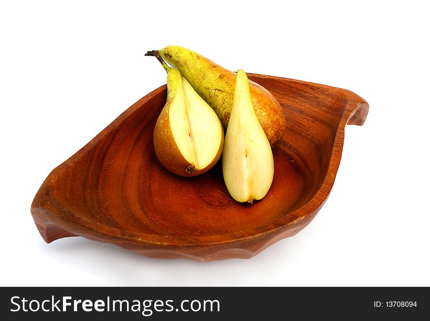 Pear on a wooden plate on a white background