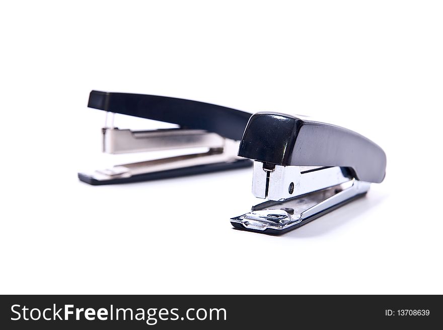 Two black staplers isolated on white background