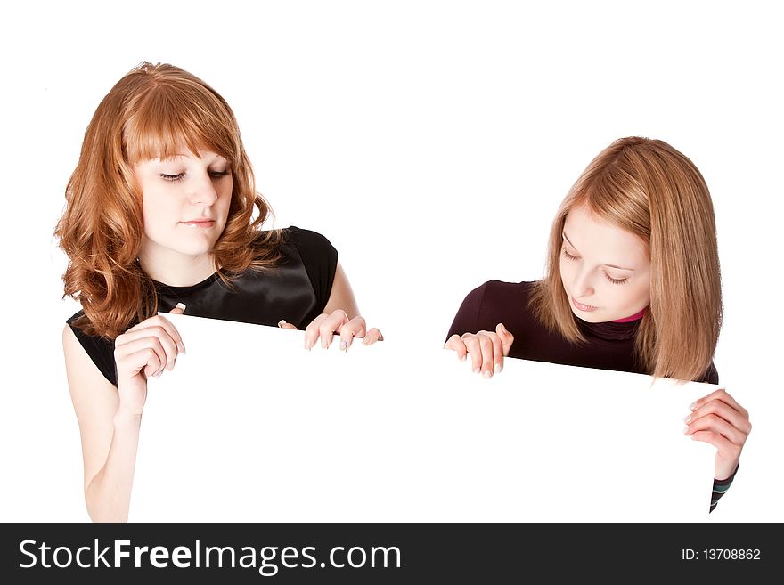 Two girls with white paper in hands. Isolated on white