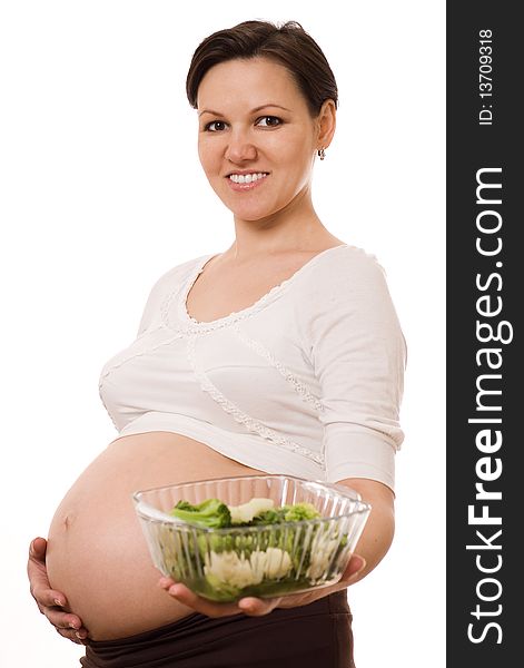 Pregnant woman with vegetables on white background