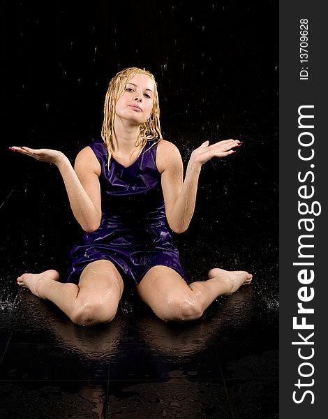 Full length portrait of a woman in water studio