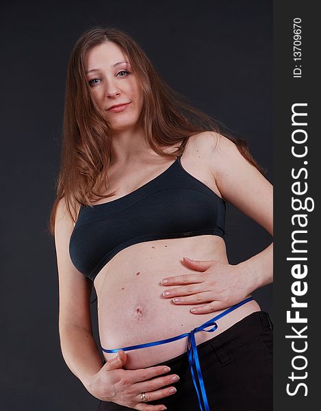 Nine month pregnant beautiful woman holding her belly to getting touch her unborn baby. Nine month pregnant beautiful woman holding her belly to getting touch her unborn baby.