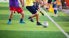 Soccer Players Run To Trap And Control The Ball For Shoot To Goal With Cheerleader Team Background Royalty Free Stock Image