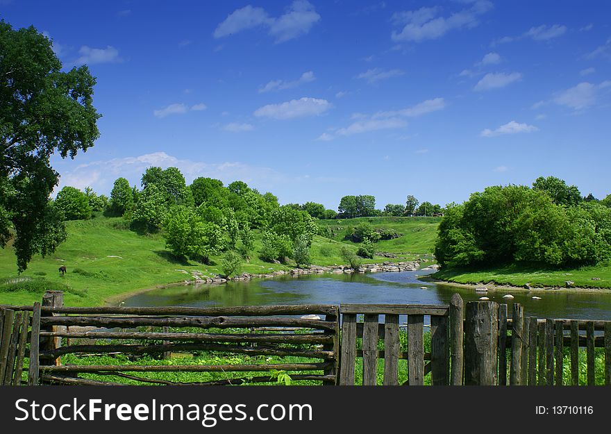 Nice village summer landscape with river and blue sky