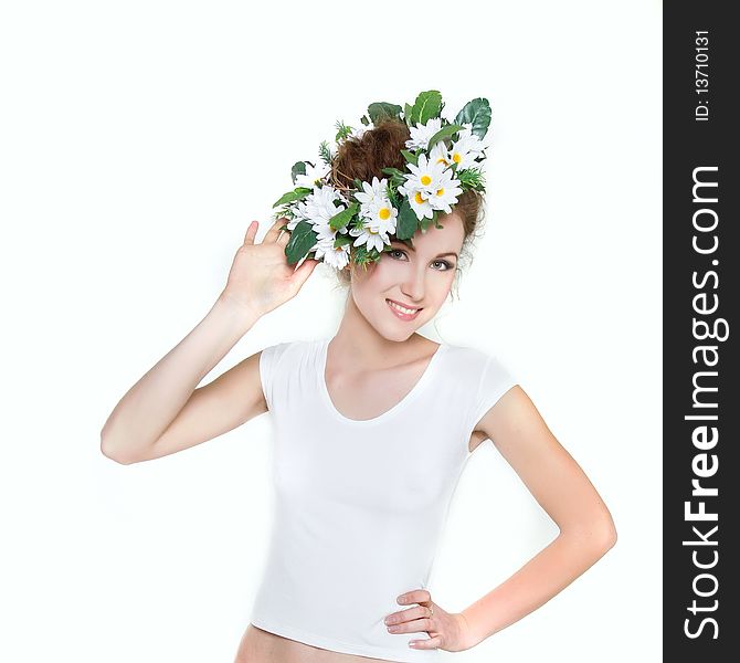 Young beautiful woman in floral wreath over white