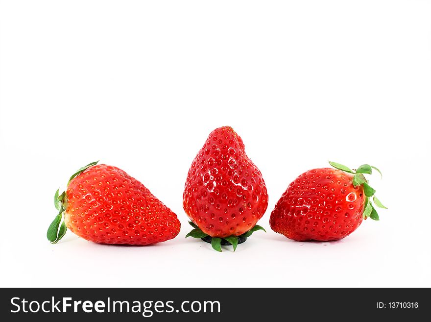 Three fresh ripe strawberries isolated on white background. Three fresh ripe strawberries isolated on white background