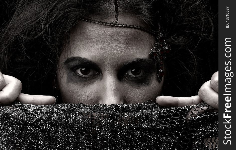 Portrait of a witch with jewelry on a dark background. Portrait of a witch with jewelry on a dark background