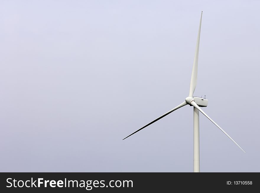 Isolated solitary windmill against a white sky and homogeneous. Isolated solitary windmill against a white sky and homogeneous