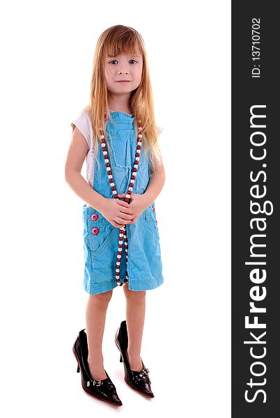 Small blonde girl in mam's high-heeled shoes on white background. Small blonde girl in mam's high-heeled shoes on white background